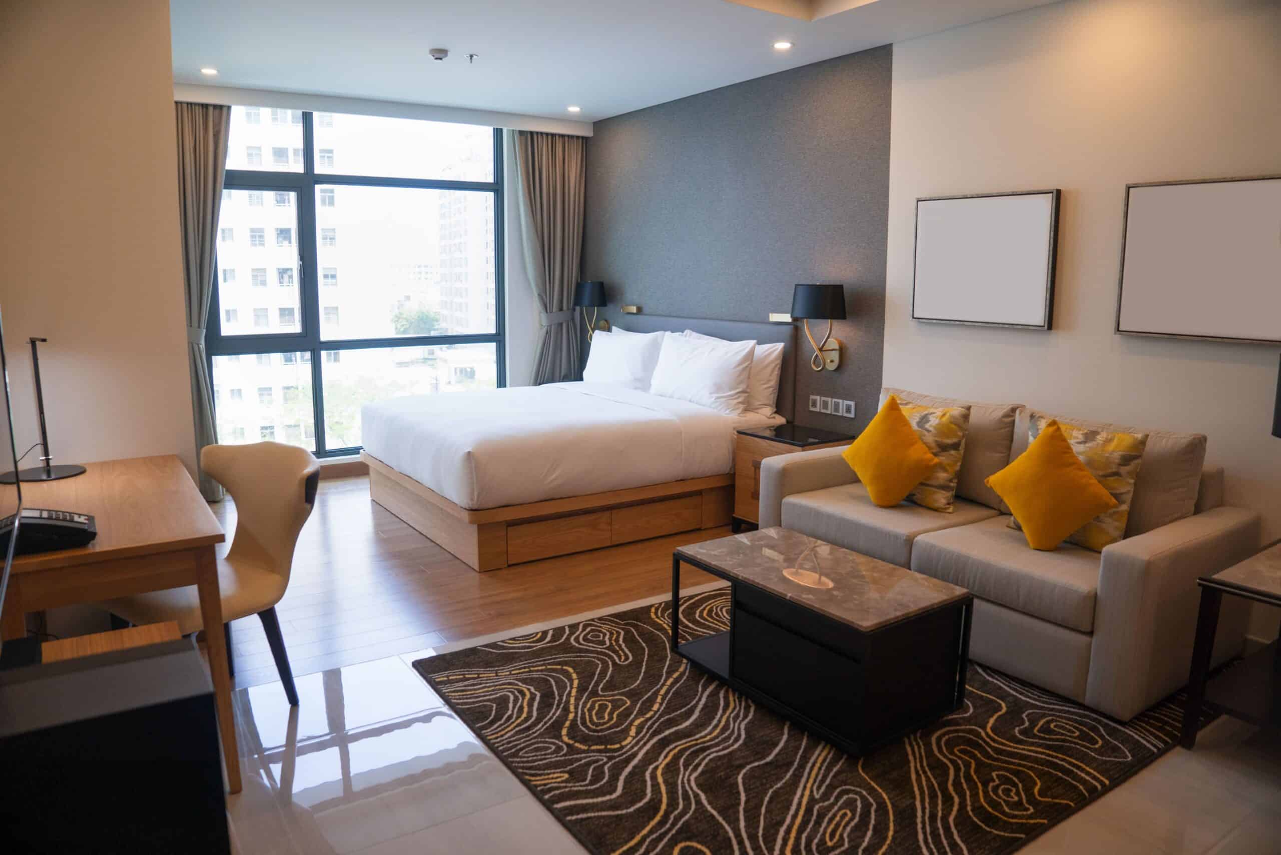modern-studio-apartment-design-with-bedroom-living-space (1) Modern, stylish room with bed, living room, and workspace in one of the Cape Town Furnished Apartments