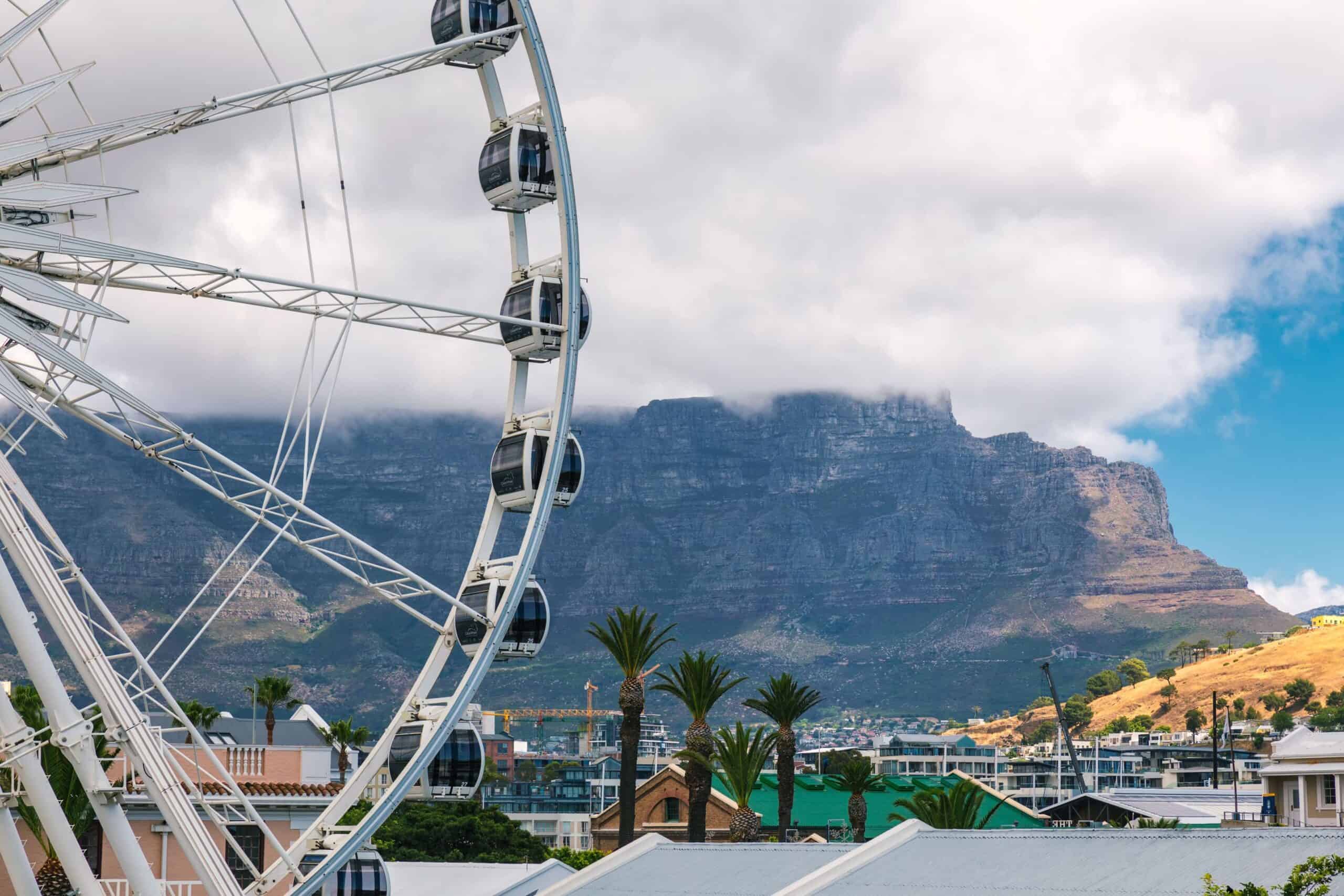ferris-wheel-waterfront-cape-town-table-mountain (1) A closeup of the ferris wheel at the V&A Waterfront and Table Mountain in Cape Town.